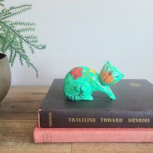 Green cat figurine.